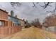 Exterior view of townhomes with varying colors, featuring fenced backyards for privacy at 11973 E Kepner Dr, Aurora, CO 80012