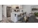 Bright, modern kitchen with stainless steel appliances and a breakfast bar at 11973 E Kepner Dr, Aurora, CO 80012