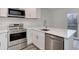 Modern kitchen equipped with stainless steel appliances, including a stove, dishwasher, and microwave at 11973 E Kepner Dr, Aurora, CO 80012