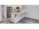 Modern kitchen featuring stainless steel appliances and a breakfast bar at 11973 E Kepner Dr, Aurora, CO 80012