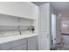 Bright laundry room with washer, dryer, and shelving at 11973 E Kepner Dr, Aurora, CO 80012