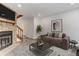 Comfortable living room with stone fireplace and hardwood stairs at 11973 E Kepner Dr, Aurora, CO 80012