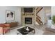 Cozy living room with a stone fireplace, modern decor and wood stairs leading to upper level at 11973 E Kepner Dr, Aurora, CO 80012