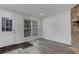 Living room featuring a stone fireplace, a large window and a white painted front door at 11973 E Kepner Dr, Aurora, CO 80012