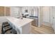 Modern kitchen featuring stainless steel appliances, a bright countertop island, and pristine white cabinets and countertops at 13518 E 103Rd Pl, Commerce City, CO 80022