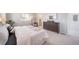 Spacious primary bedroom with a view to a modern en-suite and a stylish dresser at 13518 E 103Rd Pl, Commerce City, CO 80022