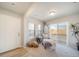 Inviting sitting area with chair, side table, and sliding glass doors to balcony at 13518 E 103Rd Pl, Commerce City, CO 80022