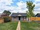 Charming single-story home with a well-maintained front yard and inviting brick pathway at 6608 Hooker St, Denver, CO 80221