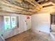 Living room featuring original hardwood floors, new windows and a rustic ceiling at 6608 Hooker St, Denver, CO 80221