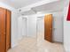 Open basement area with tile flooring and neutral paint, accessible to other rooms at 12022 W Louisiana Ave, Lakewood, CO 80228