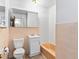 Bathroom with toilet, sink, vanity, and bath tub with peach tile at 12022 W Louisiana Ave, Lakewood, CO 80228