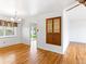 Light-filled dining room featuring hardwood floors, a stylish chandelier, and a built-in cabinet, perfect for entertaining guests at 12022 W Louisiana Ave, Lakewood, CO 80228