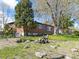 Brick home featuring mature trees, a well-kept lawn, and attractive curb appeal at 12022 W Louisiana Ave, Lakewood, CO 80228