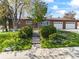 Charming brick ranch home featuring a two-car garage and landscaped front yard with mature trees in a suburban neighborhood at 12022 W Louisiana Ave, Lakewood, CO 80228