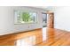 Bright living room boasts hardwood floors, a large window with neighborhood views, and a stylish front door at 12022 W Louisiana Ave, Lakewood, CO 80228
