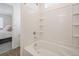 Tiled shower/bath combination with chrome fixtures, neutral walls, and plenty of natural light at 22093 E 38Th Pl, Aurora, CO 80019