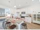 Bright kitchen with granite countertops, white cabinets, a central island, and stainless steel appliances at 22093 E 38Th Pl, Aurora, CO 80019