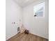 The laundry room has wood-look floors and a window for natural light at 22093 E 38Th Pl, Aurora, CO 80019