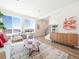 Bright living room featuring large windows, wood floors, modern furniture, and stylish decor at 22093 E 38Th Pl, Aurora, CO 80019