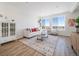 Bright living room with modern decor, large windows, and hardwood floors at 22093 E 38Th Pl, Aurora, CO 80019