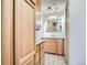 Bathroom featuring tile floors, light wood cabinets, mirror, and vanity lights at 3131 E Alameda Ave # 1503, Denver, CO 80209