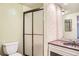 Bathroom featuring a shower with glass doors, a toilet, and a pink vanity at 3131 E Alameda Ave # 1503, Denver, CO 80209