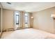 Bright bedroom featuring carpet floors, two windows with city views, and neutral colored walls at 3131 E Alameda Ave # 1503, Denver, CO 80209
