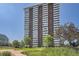 High-rise apartment building with manicured green space at 3131 E Alameda Ave # 1503, Denver, CO 80209