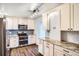 Updated kitchen features stainless appliances, modern cabinetry, stone counters, and stylish tile backsplash at 3131 E Alameda Ave # 1503, Denver, CO 80209