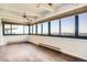 Spacious living room with hardwood floors, large windows with blinds, and a ceiling fan at 3131 E Alameda Ave # 1503, Denver, CO 80209