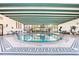 Indoor swimming pool features tiled deck, lounge chairs, and lots of natural light at 3131 E Alameda Ave # 1503, Denver, CO 80209
