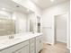 Bright bathroom features a double vanity, walk-in closet and a glass-enclosed shower at 24088 E Atlantic Pl, Aurora, CO 80018