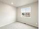 Cozy bedroom with a window view, carpeted floors, and ample natural light, creating a serene and inviting atmosphere at 24088 E Atlantic Pl, Aurora, CO 80018