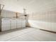 Empty two car garage with a large windowed garage door and plenty of overhead space at 24088 E Atlantic Pl, Aurora, CO 80018