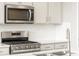 Modern kitchen with stainless steel appliances and sleek, white cabinetry at 24088 E Atlantic Pl, Aurora, CO 80018