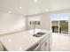 Bright kitchen featuring a center island with a double sink and barstool seating at 24088 E Atlantic Pl, Aurora, CO 80018