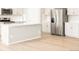 Modern kitchen with stainless steel appliances, an island and sleek, white cabinetry at 24088 E Atlantic Pl, Aurora, CO 80018