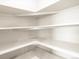 Walk-in pantry with ample shelving, providing organized storage for all your kitchen essentials and supplies at 24088 E Atlantic Pl, Aurora, CO 80018