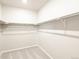Walk-in closet features carpet and shelving for ample storage at 24088 E Atlantic Pl, Aurora, CO 80018