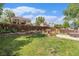 Fenced backyard featuring a grassy area, and a hot tub on a concrete slab, and a home with a deck in the background at 11407 W 103Rd Ave, Broomfield, CO 80021