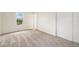 Bright bedroom with neutral carpet and a view of the neighborhood through a window at 11407 W 103Rd Ave, Broomfield, CO 80021