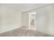 Bedroom with neutral carpet that leads into a hallway with stairs at 11407 W 103Rd Ave, Broomfield, CO 80021