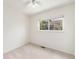 Bedroom features a ceiling fan, neutral carpet, and a window with a backyard view at 11407 W 103Rd Ave, Broomfield, CO 80021