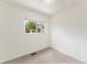 Bedroom features a window with a view, neutral carpet, and ample natural light at 11407 W 103Rd Ave, Broomfield, CO 80021