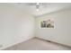 Cozy bedroom with neutral carpet, ceiling fan, and a bright window view at 11407 W 103Rd Ave, Broomfield, CO 80021