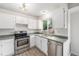 Well-lit kitchen features stainless steel appliances, light countertops, and white cabinetry at 11407 W 103Rd Ave, Broomfield, CO 80021