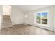 Open living area with wood floors, natural light, and carpeted stairs at 11407 W 103Rd Ave, Broomfield, CO 80021