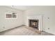 Comfortable living room features a classic brick fireplace and large window at 11407 W 103Rd Ave, Broomfield, CO 80021