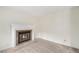 Comfortable living room featuring a classic brick fireplace on neutral carpeting at 11407 W 103Rd Ave, Broomfield, CO 80021
