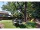 Serene backyard oasis with a dining set, lush greenery, and play structure at 7869 S Valentia St, Centennial, CO 80112